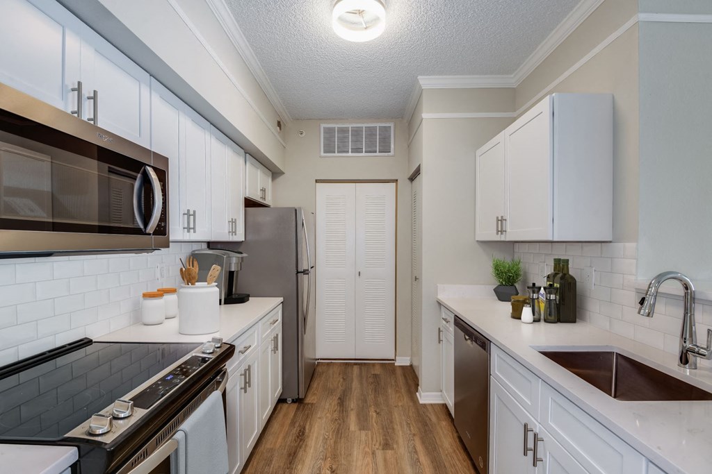 Kitchen with white cabinetry at Ashlar, Fort Myers