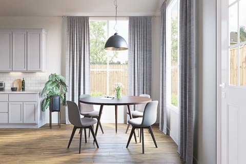 A dining room with a table and chairs.