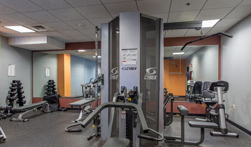 Fitness center features cardio equipment and free weights at Residences at Manchester Place, Manchester