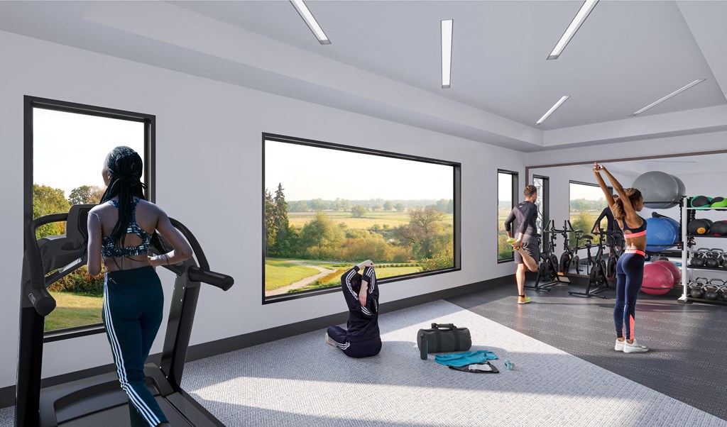 a group of people working out in a gym with large windowsat SoRoc On Maine, Rochester 