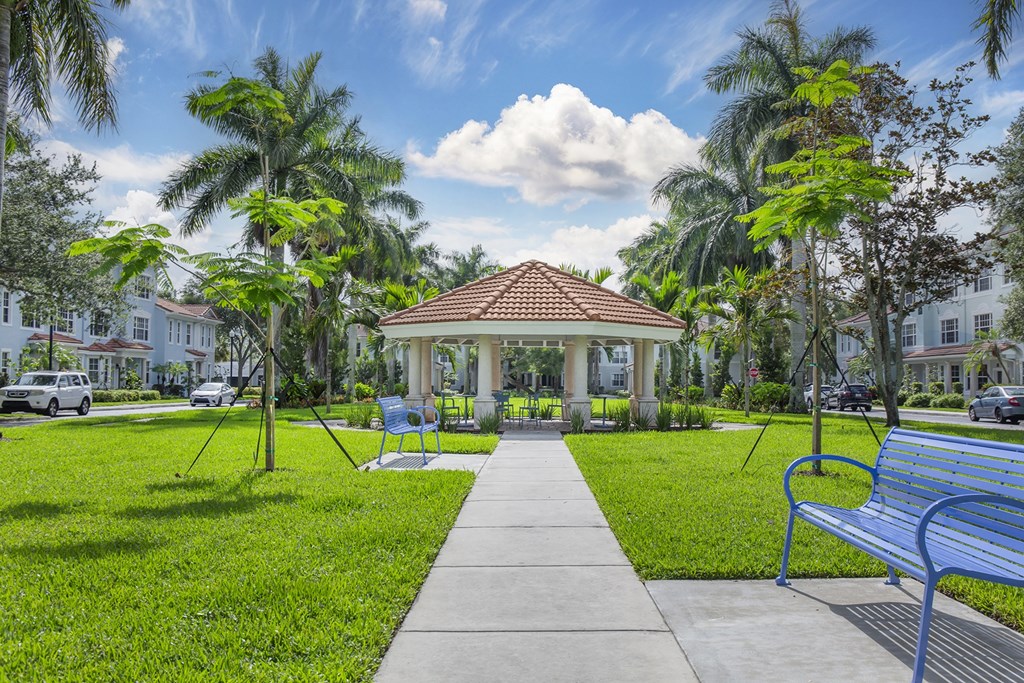 A park with a gazebo, benches, and trees at Floresta apartments in Jupiter, FL