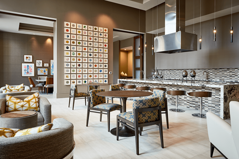 A modern dining room with a large table and chairs.