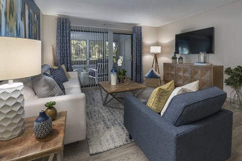 Living room with balcony access at Saddleworth Green, Ocala, FL