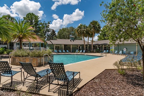 Community pool with lounge chairs  at Saddleworth Green, Florida