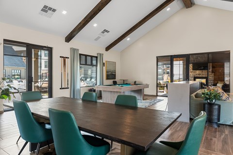 A modern meeting room with a large table and chairs.
