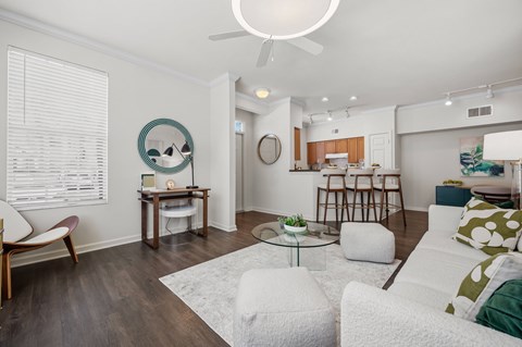 A living room with a white couch and a coffee table.