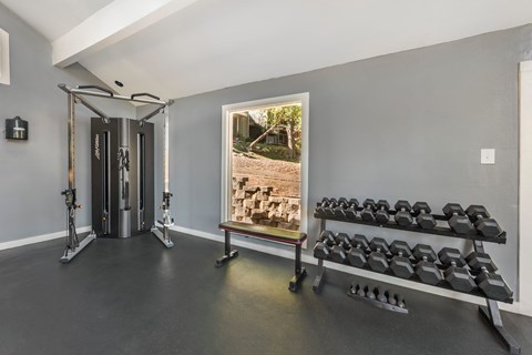Gym room with a row of dumbbells at Great Hills, Austin, TX