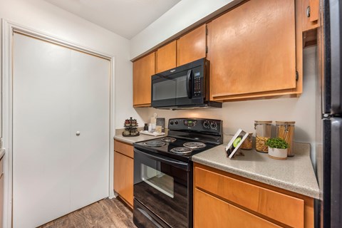 Kitchen with a black microwave above the stove at Great Hills, Austin, 78759  