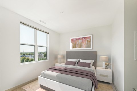 a bedroom with a bed and two windows at The Merc, Waltham