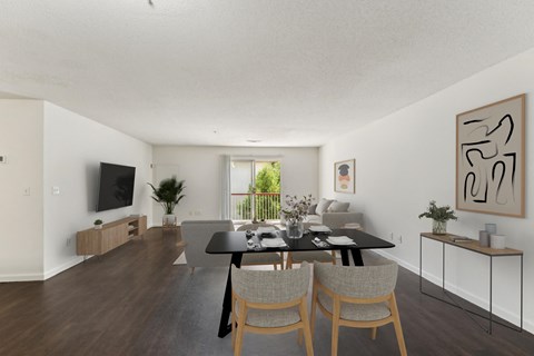 a living room and dining room with a black table and chairs at Residences at Westborough Station, Westborough, MA, 01581