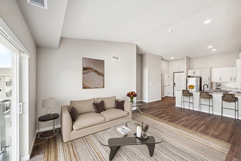 A modern living room with a beige couch and a coffee table.