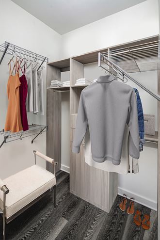 a spacious wardrobe with a bench and hangers - Photo Gallery 5