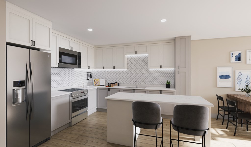 a kitchen with a large island and stainless steel appliancesat SoRoc On Maine, Rochester Minnesota