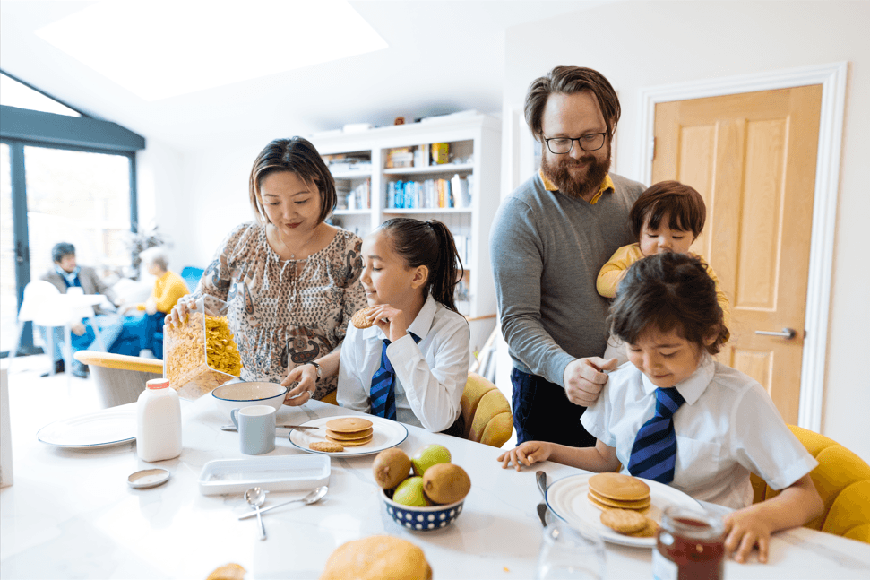 a family gathered around a table eating breakfast together