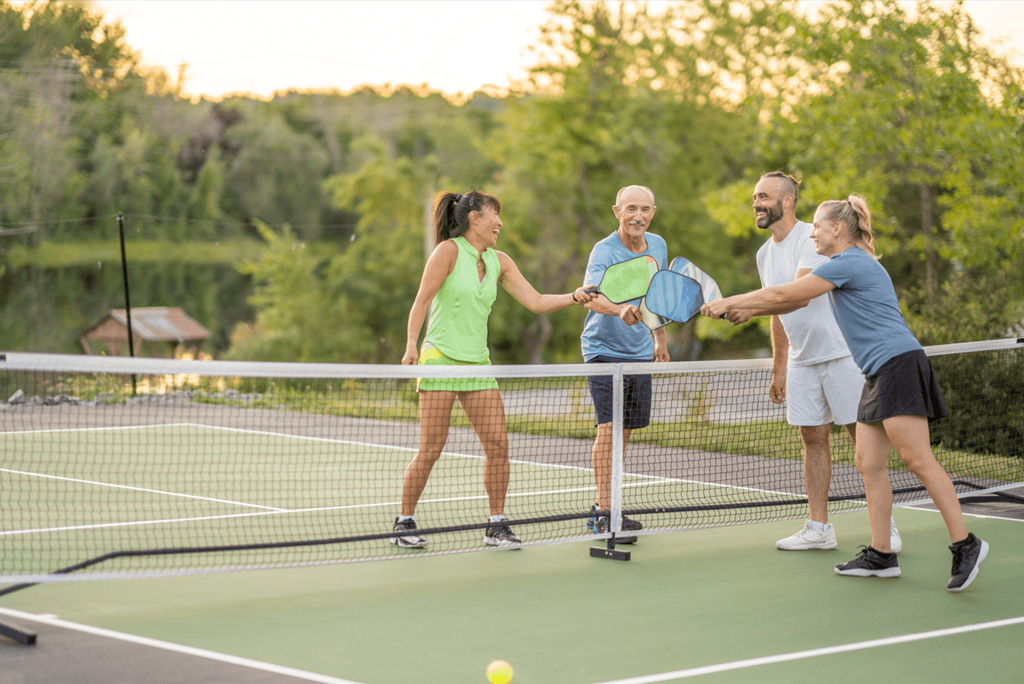 a group of people shaking hands on a tennis court