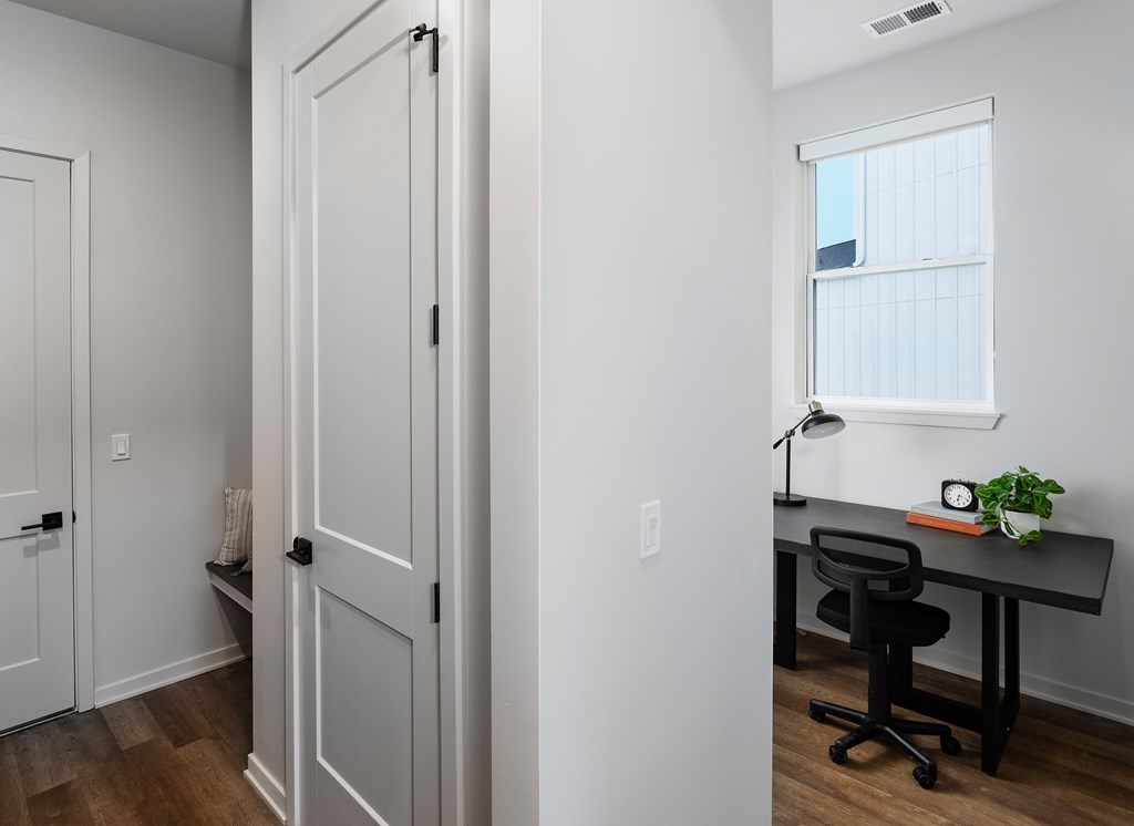 A room with a desk and a chair.