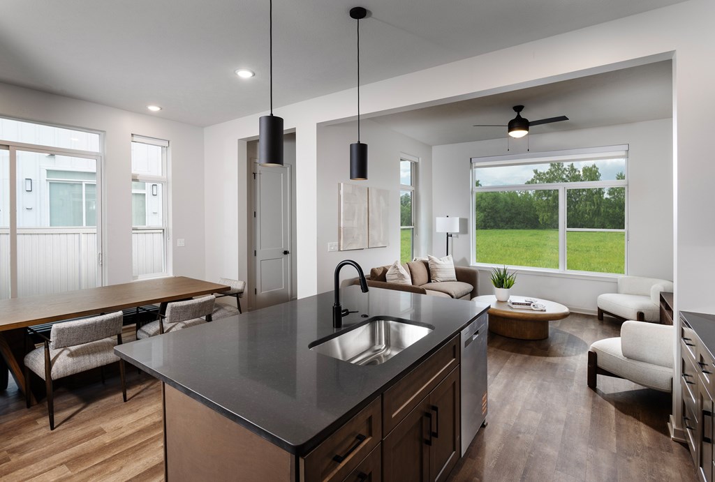 A modern kitchen with a large island and a dining table.