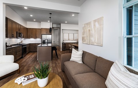 A modern living room with a brown sofa and a coffee table.