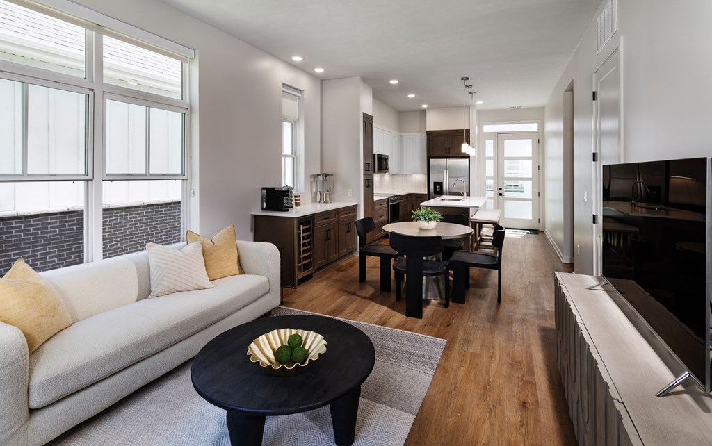A modern living room with a white sofa and a black coffee table.