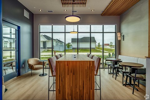 A modern dining room with a wooden table and chairs.