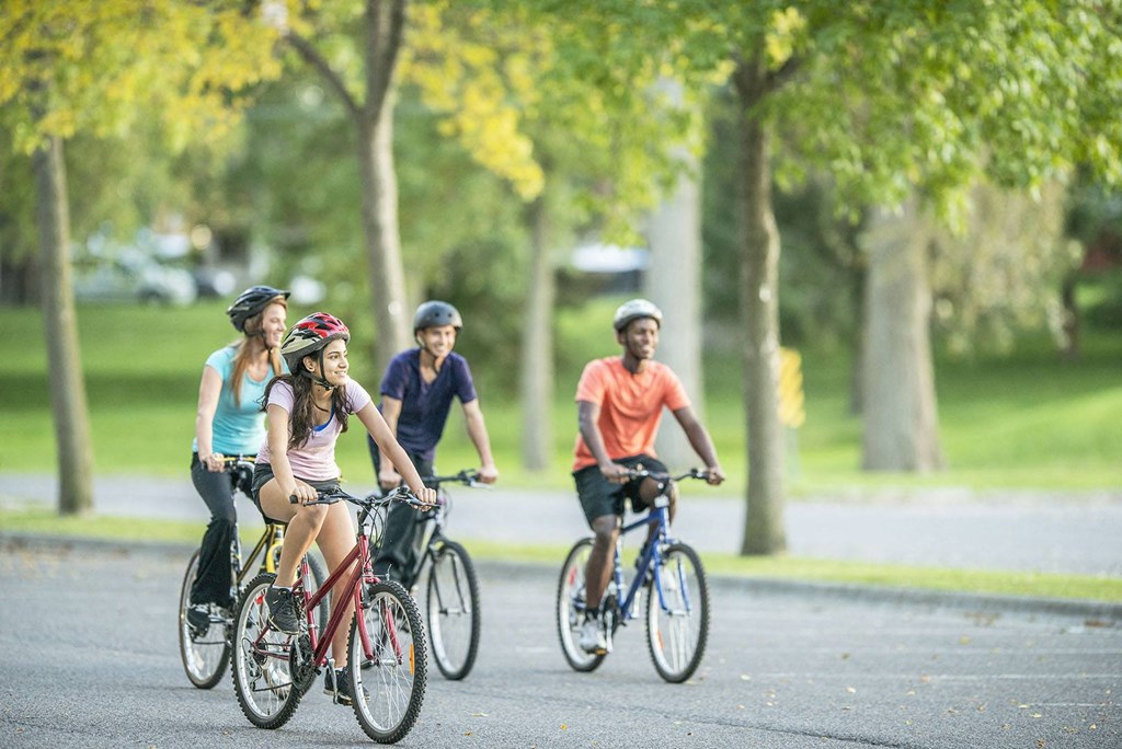 a group of people riding bikes down a street