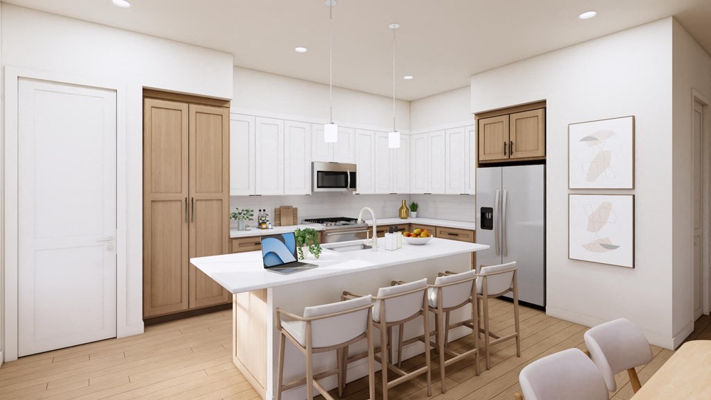 a white kitchen with a large island and white chairs
