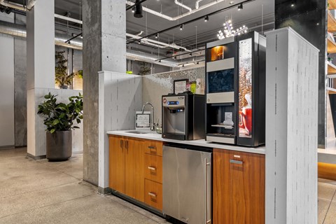 A modern kitchen with wooden cabinets and a stainless steel refrigerator.