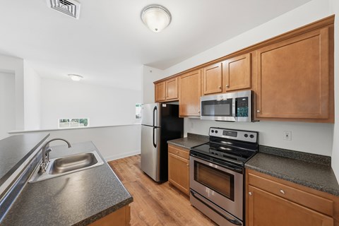 A kitchen with wooden cabinets and stainless steel appliances.