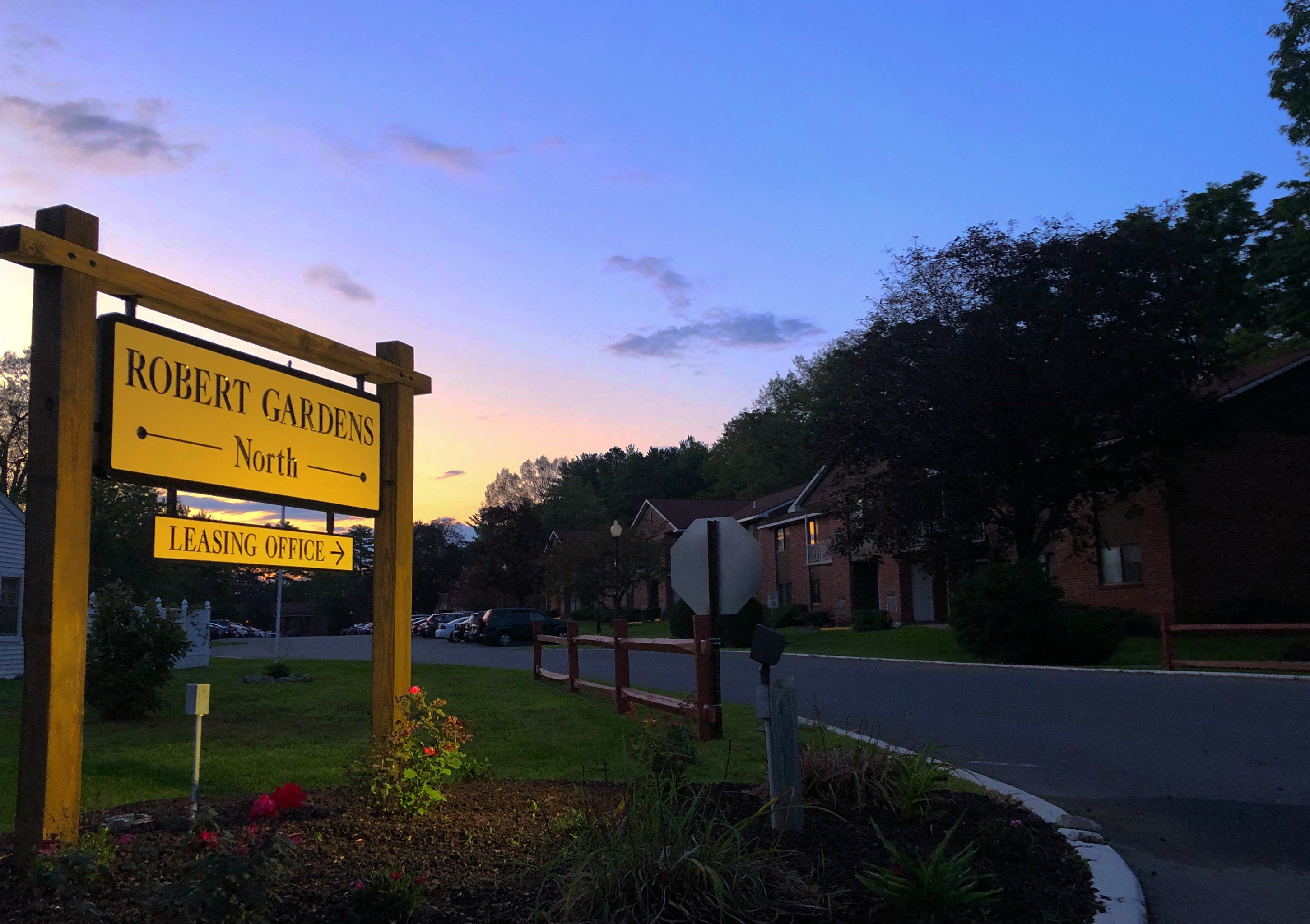the sign for rocket garden north at sunset