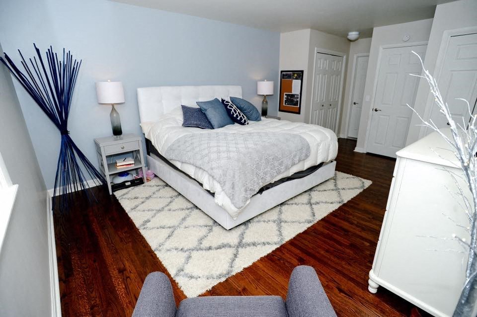 a bedroom with a bed and a rug