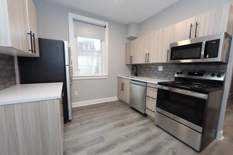 a kitchen with stainless steel appliances and a window