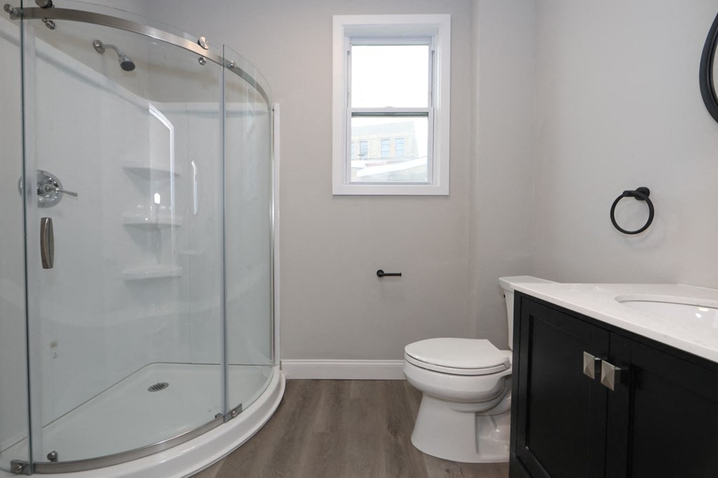 a bathroom with a toilet and a glass shower