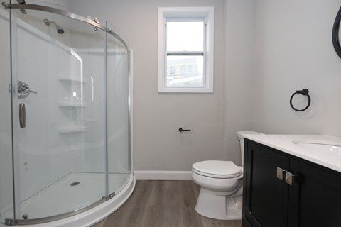 a bathroom with a toilet and a glass shower