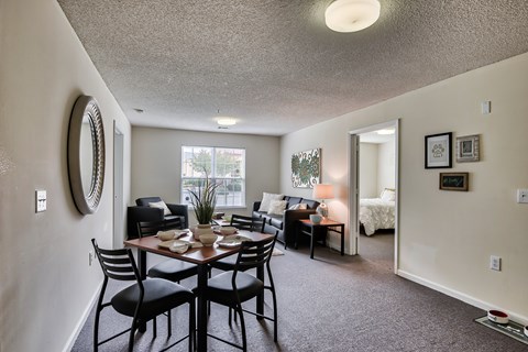 A dining room with a table set for four.