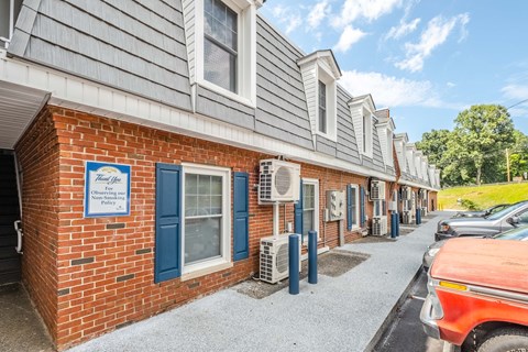 A row of houses with a sign that says "Amenities Off" on the front.