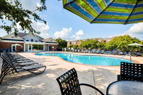 A pool area with sun loungers and a table.
