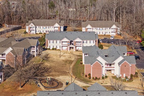 A bird's eye view of a residential area with houses and a playground.