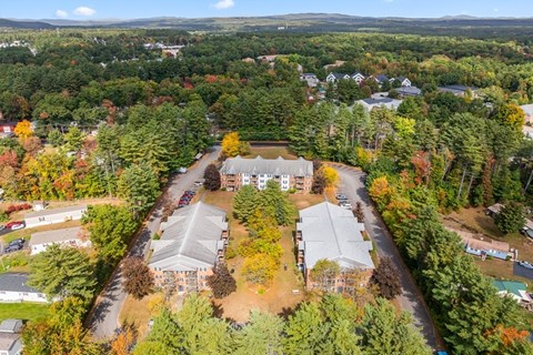 An aerial view of a residential area with houses and trees.