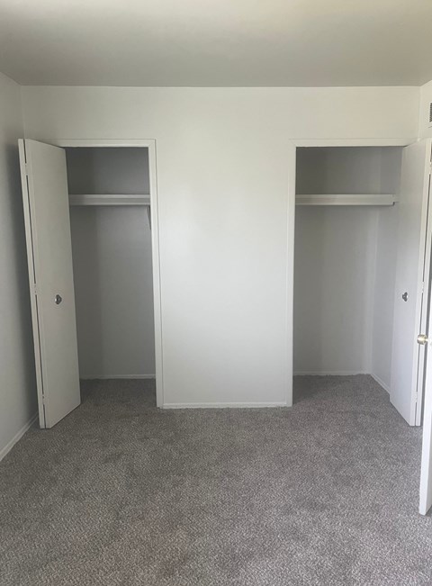 The bedroom in a 1 bedroom unit with 2 closets