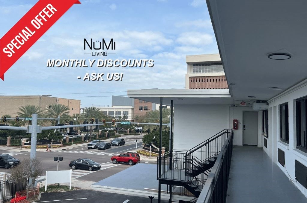 a building with a balcony overlooking a parking lot