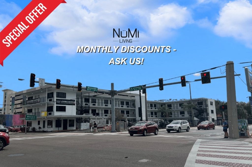 an image of a building at an intersection with traffic lights