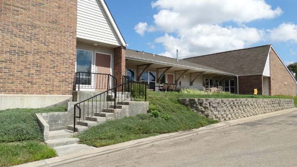 a house with stairs and a sidewalk in front of it