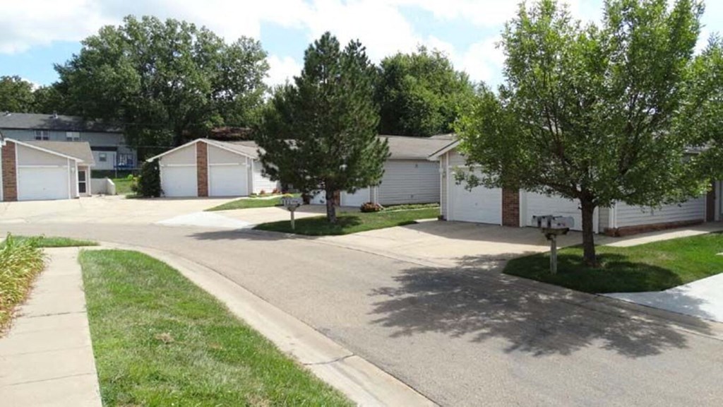 a street with a row of houses and trees