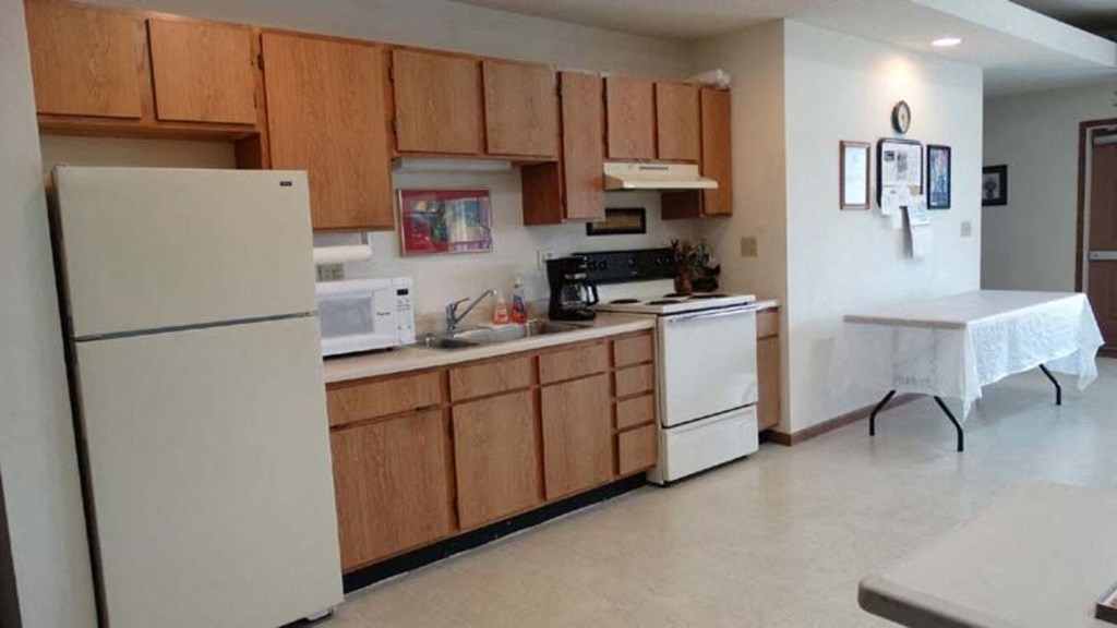 a kitchen with white appliances and a table