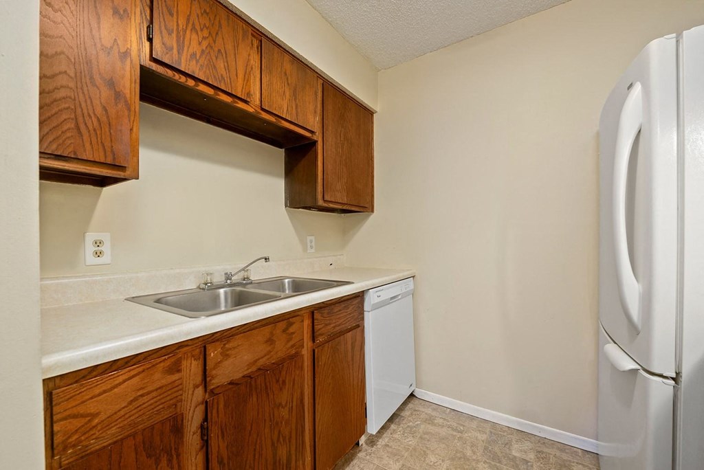 a kitchen with a sink and a refrigerator