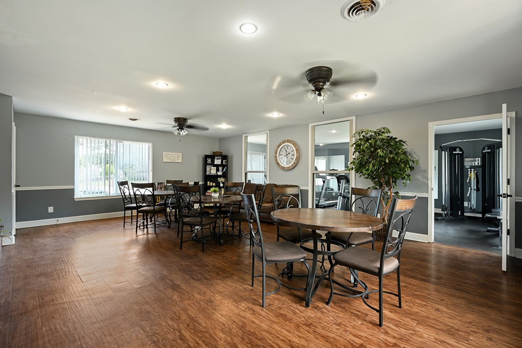 A dining room with a wooden table and chairs.