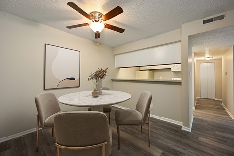 A dining room with a white table and chairs.