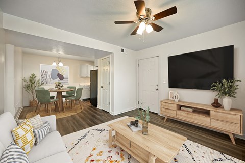 A living room with a white couch and a wooden coffee table.
