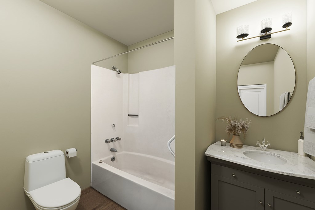 A white toilet sits next to a white bathtub in a bathroom.