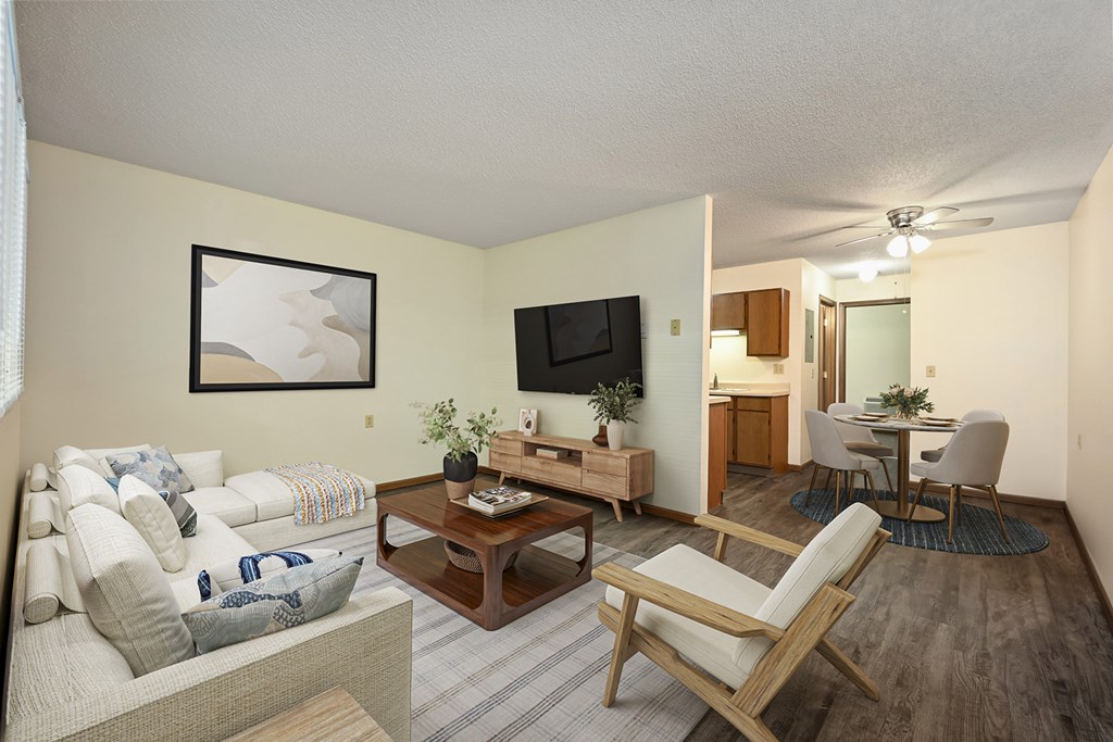 A living room with a couch, chair, and television.